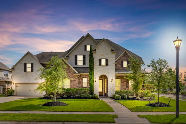 Luxury home exterior at twilight in The Woodlands, TX